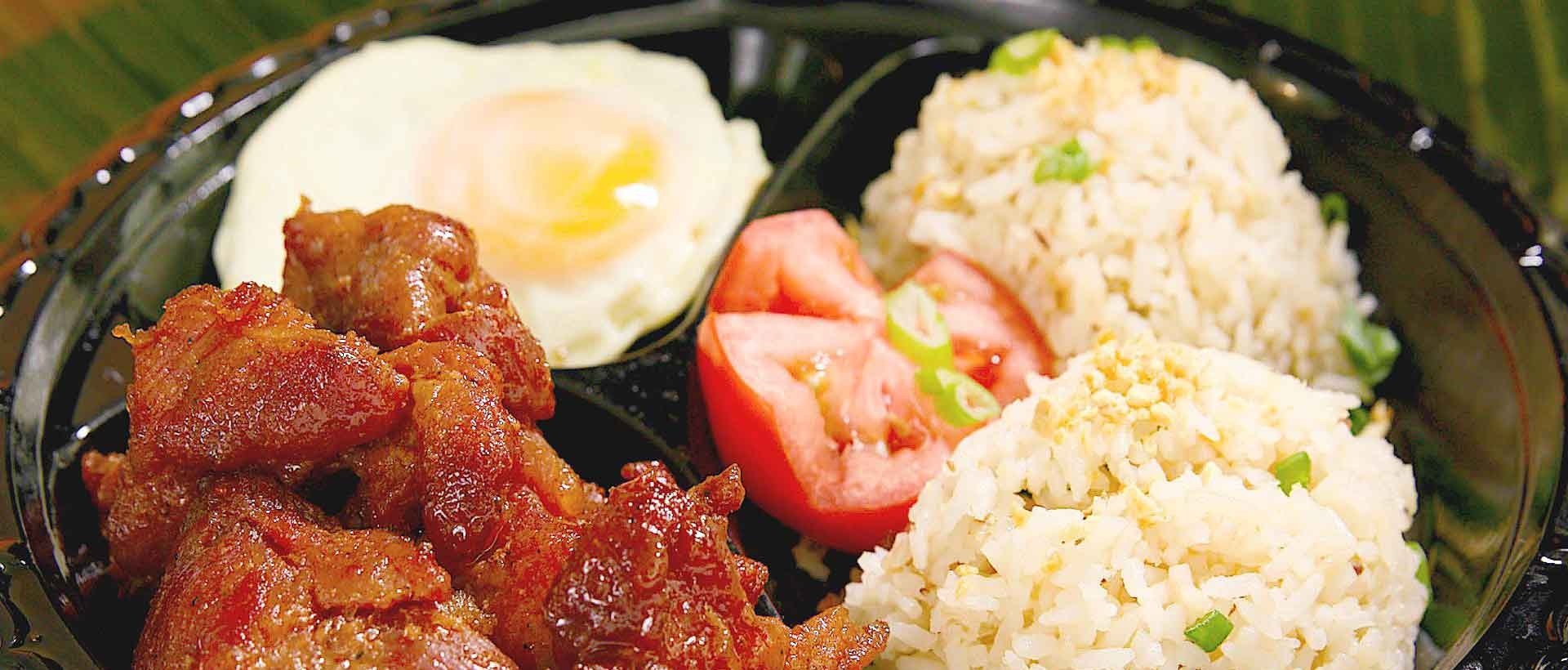 Tapsilog breakfast with cured beef tapa, garlic rice and fried egg